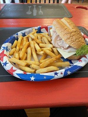 Turkey and American sandwich with French fries.