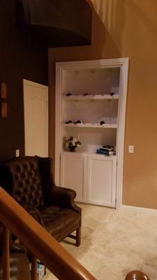 Door/wine cabinet closed to look like a custom shelving unit.