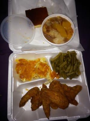 Fried chicken wings, green beans, mac and cheese, cornbread, and peach cobbler.