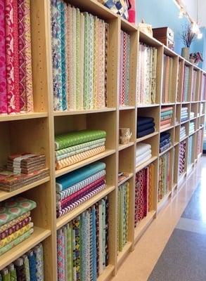 Beautiful wall of fabrics!  Moda, Free Spirit, Art Galler, Riley Blake, Northcott... And more!