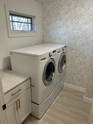 freshened up this laundry room with paint, wallpaper, and new flooring!