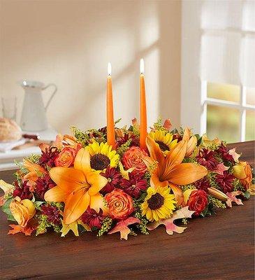 WARM FALL CENTERPIECE This vibrant arrangement is filled with a gathering of fresh-picked blooms in brilliant colors.