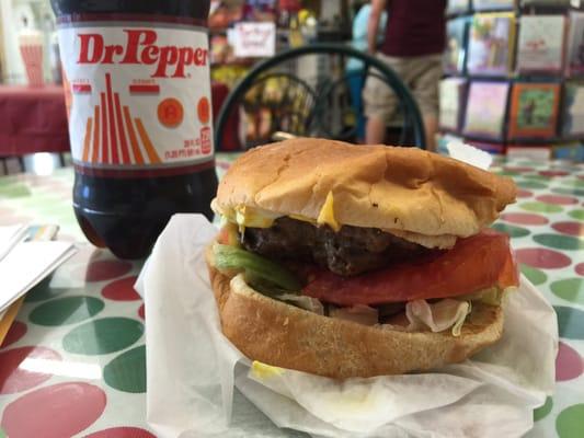 Home made cheeseburger... Burger is thick... Tomatoes are cut crooked and the bun is fresh... Great place!