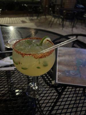 Jalapeño margarita on the rocks with tajin rim