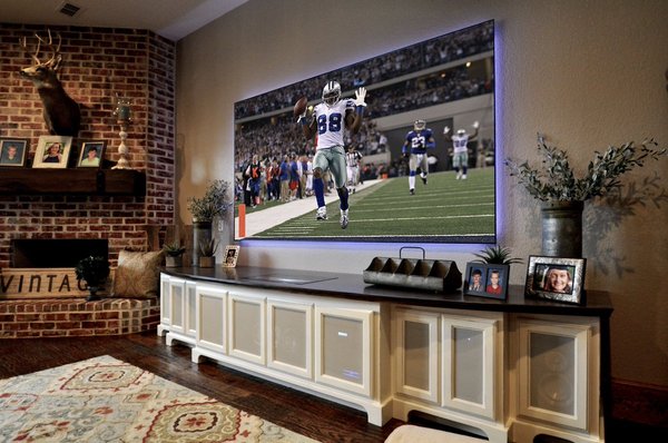 Ultra short throw projector and 110" screen in fully lit family room, projector is in the cabinet below screen!