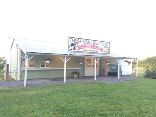 Outside of the place. There are a couple of picnic tables to sit at in the shade.