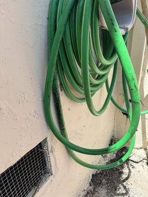 Tar splattered onto the side of my house, hose, and dried dripping out of the down spout.