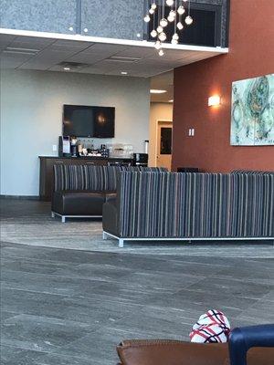 Complimentary coffee/tea bar with cookies and water. Vending machine behind it.