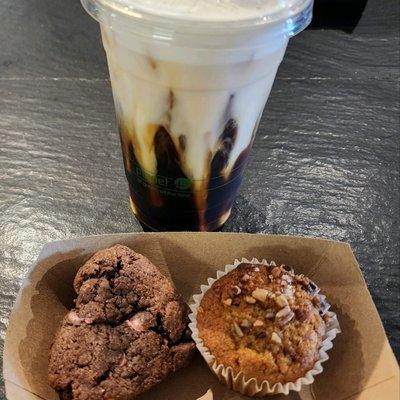 Cold brew with a cold foam served with a ruby chocolate, chocolate chip cookie and a pumpkin muffin topped with pecans and brown sugar