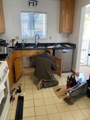 Victor working on hooking up the dishwasher