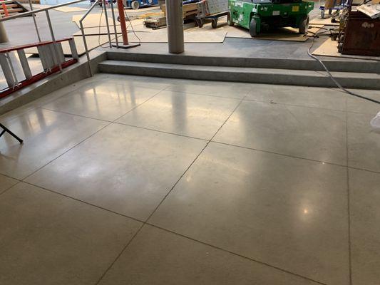 Polished concrete, sawcut joints filled.