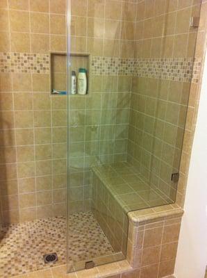 Custom tile shower with bench seat.