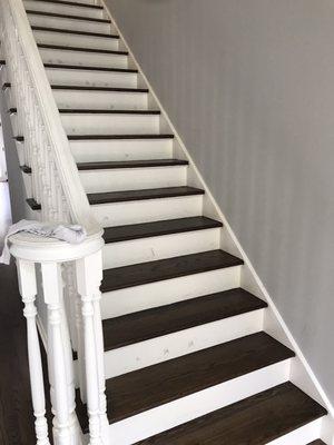 No wood floor stain splatters on painted risers - expert care!