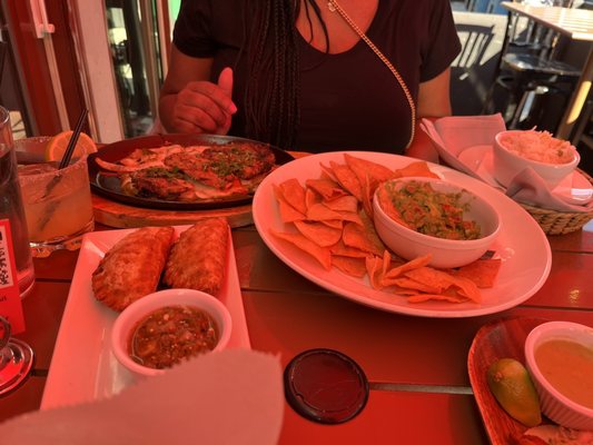 Steak Fajitas back. Guacamole center. Chicken Empanadas far left,