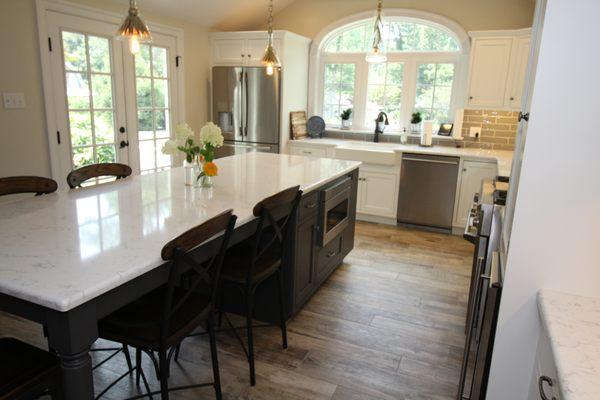 Two tone kitchen with white perimeter and dark island.