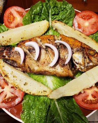 Fried whole tilapia fish with Fried yuca or Fried plantain