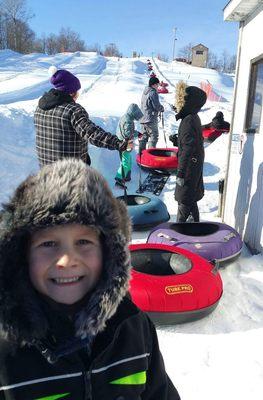 Happy kid getting ready to go back to the top with the lift.