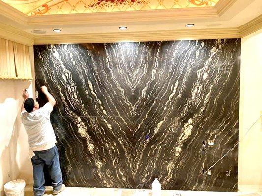 Custom Granite slab installation on a bedroom wall!