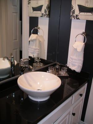 Vessel sink with hand painted walls and granite countertop