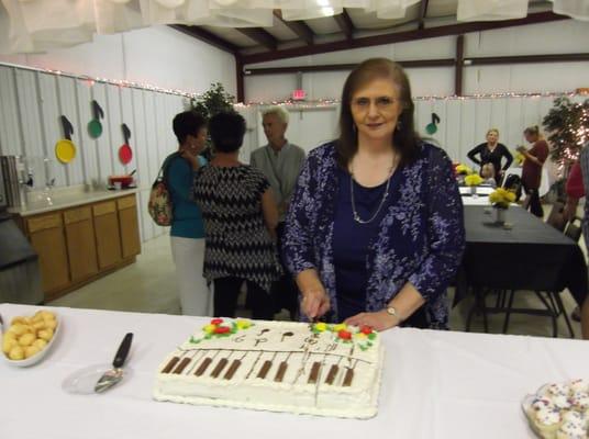 Piano Teacher, Elaine Bovender, getting ready to serve the cake at the Spring Recital