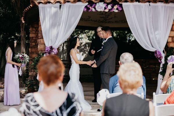 Getting an earful of hearfelt vows in front of gazebo curtains!!! Curtain & gazebo decor not included!