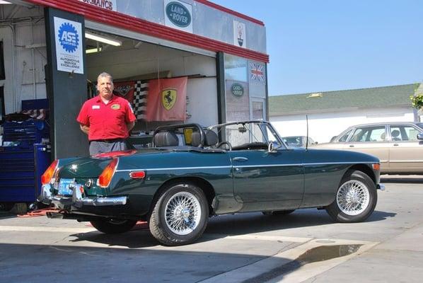 Shop owner Emile with a recently restored MGB.