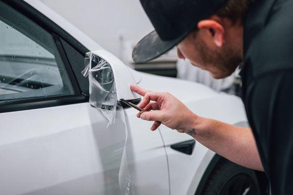 Clear Bra Being Installed On A Tesla by Chase