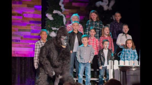 My youngest is singing in the choir (red/white shirt, top row) while this Gorilla takes the show.