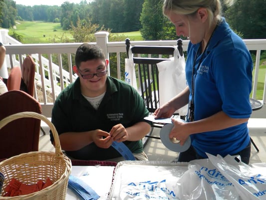 Student and staff volunteering at APTS Golf Tournament Fundraiser