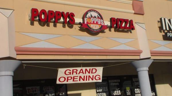 The grand opening sign that led us into Poppy's Pizza.