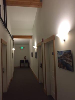 Hallway with three suite entrances and loca photos