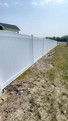 6 foot white vinyl privacy fence.