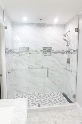 Custom shower with handle bars surrounding.