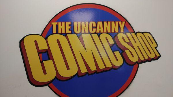 The Uncanny Comic Shop logo