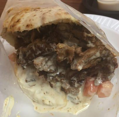 Beef shawarma in a pita, stuffed with custom sides and sauces as per customer request