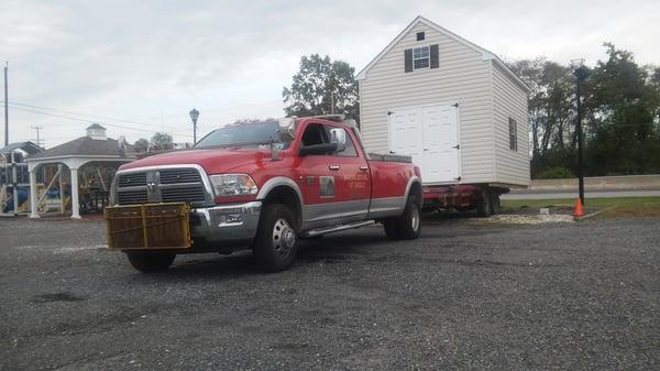 The boys moving a shed