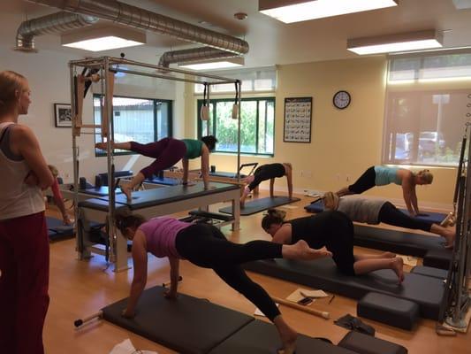 doing the mat exercises on a raised mat which helps finding the work within each movement.