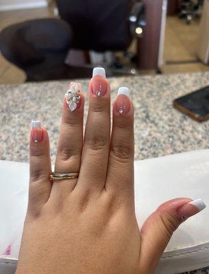 gel frenchies with a flower charm