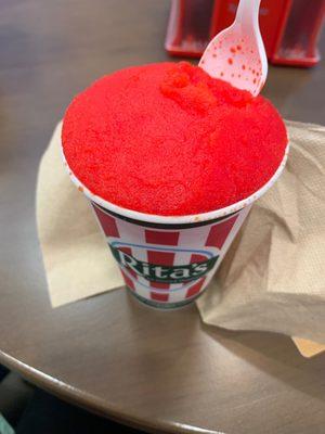 Italian ice with cherry on top and coconut on bottom!