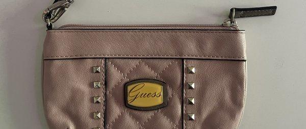 The GUESS logo on the wristlet faded into a dark yellow color :(