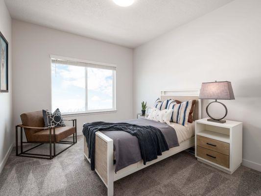 Bedroom with white walls and carpet flooring