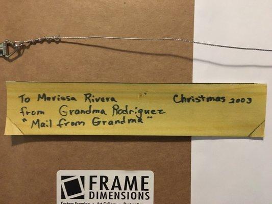 A photo saved of what's written on the original frame "To Marissa Rivera from Grandma Rodriguez, Mail from Grandma, Christmas 2003"