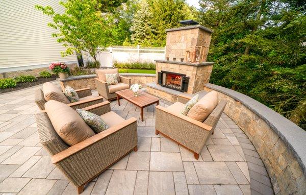 Outdoor living area with fireplace and sitting wall.