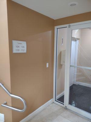 Double doors in foyer that mentions that suite #105 is down this hallway