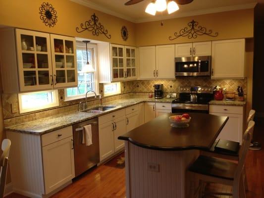 Cabinet refacing with new granite and a tile backsplash! Solid walnut accent countertop.