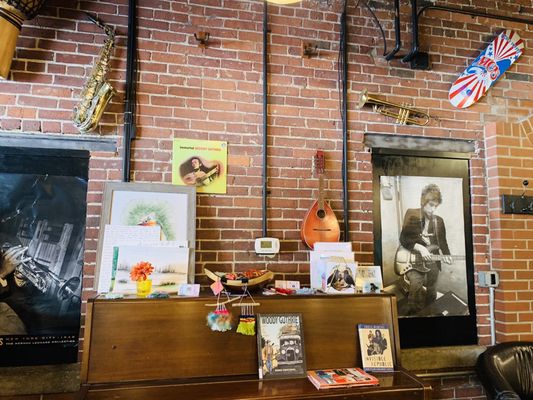 Bob Dylan and Miles Davis posters on brick add to the ambiance