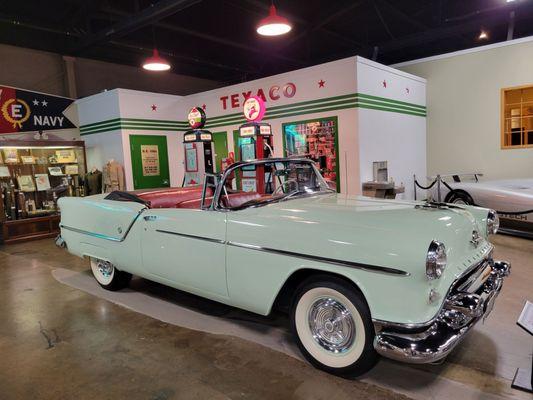 Car for photo opportunities set up by gas station