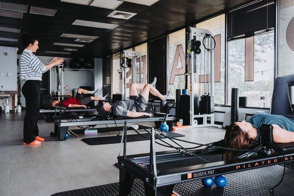 Kate Herrmann teaching Saturday morning Pilates reformer class.