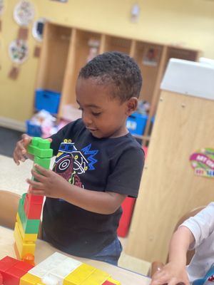 Practicing motor skills in the blocks center.