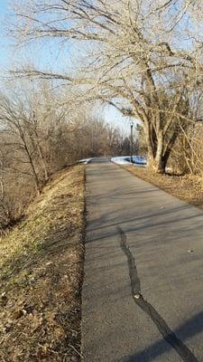 Trail across river from golf course.